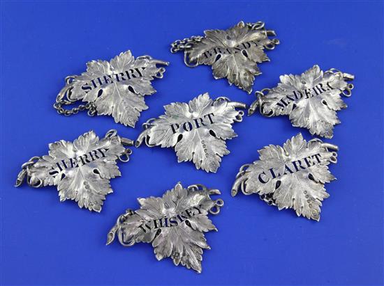 A matched set of seven Victorian silver leaf shaped wine labels, 2.5in.